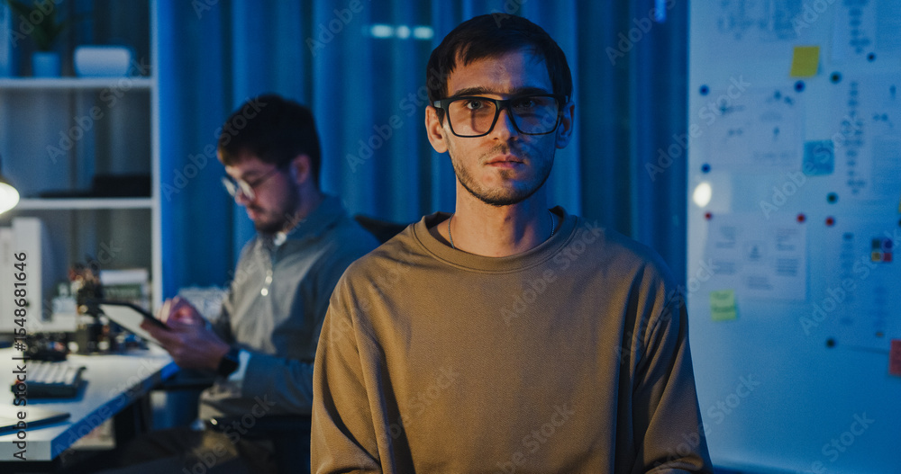 Fototapeta premium Team adult male freelance developer work late typing write prompt AI bot app program nomad terminal code at office night. Artificial intelligence dashboard, robotics, user interface, machine learning.