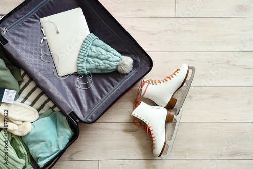 Open suitcase with winter c...