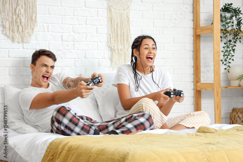 Young couple playing video ...