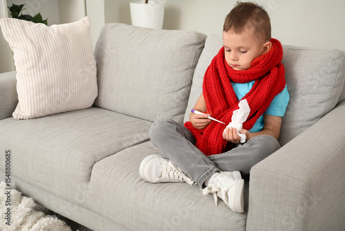 Sick little boy with thermo...