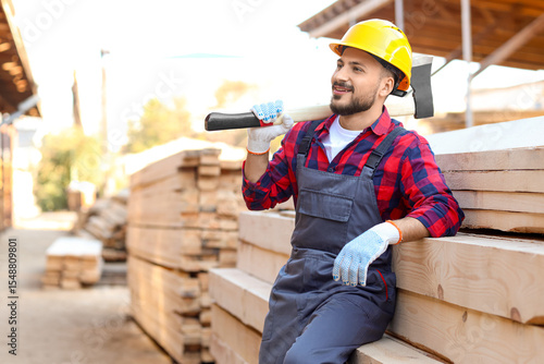 Young carpenter in hardhat ...