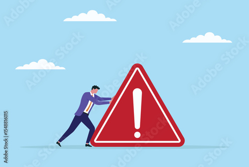 Vector illustration of a businessman trying to push and move a giant warning icon, symbolizing the struggle to overcome major risks and obstacles in the corporate world

