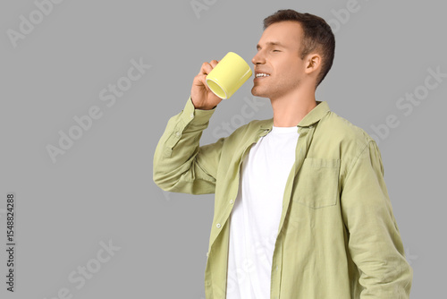 Young man drinking hot tea ...