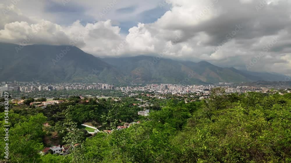 View of the city of Caracas from the La Fila Natural Park viewpoint, Cerro Avila Background. Pan left