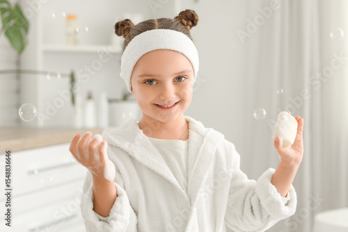 Little girl with soap bar a...