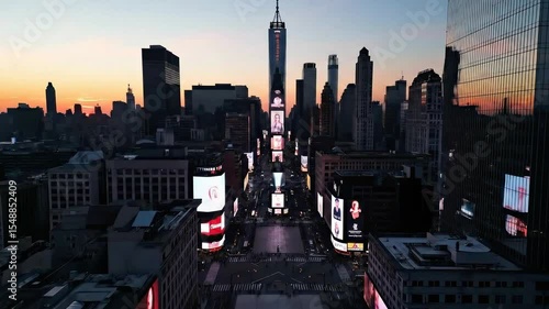Drone View Times Square at Sunset, New York City - An aerial view of Times Square in New York City at sunset, showcasing the vibrant billboards and city skyline.