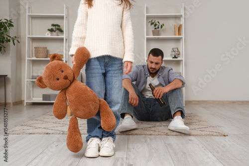 Sad girl with toy bear and ...
