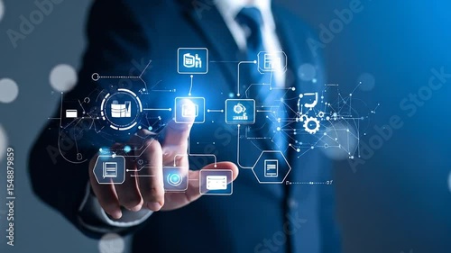 A person in a suit interacts with a digital interface displaying interconnected data elements, including graphs, icons, and gears, suggesting a workflow or process visualized through technology