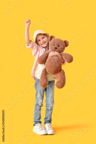 Little girl with toy bear o...