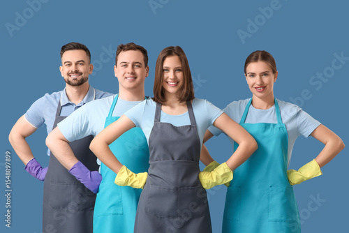 Team of young janitors in a...