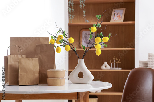 Paper bags and vase with le...