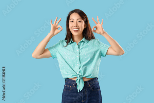 Young Asian woman showing O...