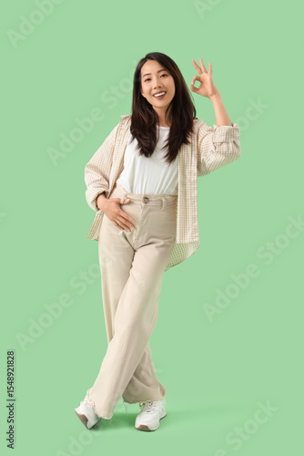 Young Asian woman showing O...