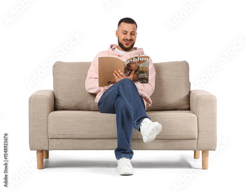Young man reading magazine ...