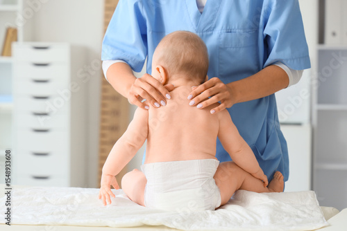 Female therapist massaging ...