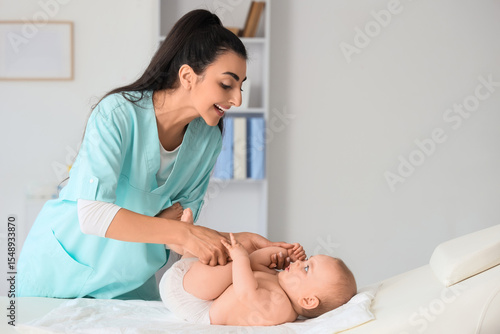 Female therapist massaging ...