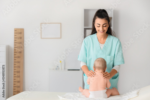 Female therapist massaging ...