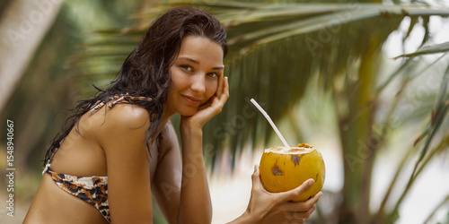 Canvastavla Beautiful Bikini Model Holding Coconut and Smiling in Tropical Setting
