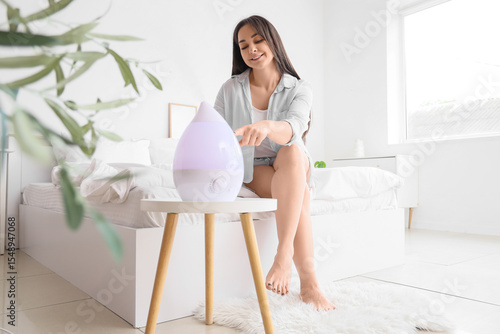 Young woman with air humidi...
