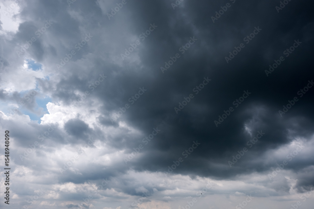 Fototapeta premium Dark sky with stormy clouds. Dramatic sky rain,Dark clouds before a thunder-storm,clouds before rain