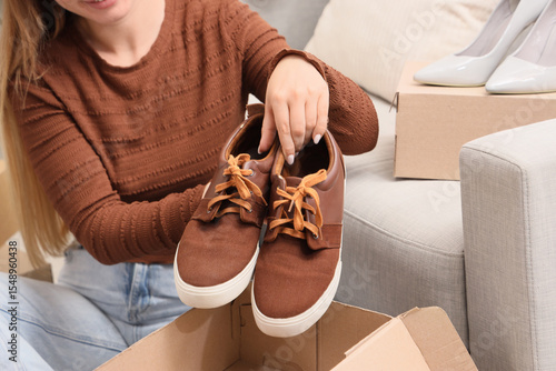 Woman putting brown sneaker...
