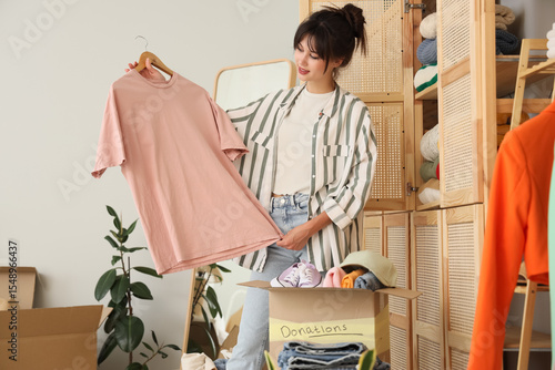 Young woman packing clothes...