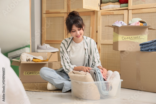 Young woman packing clothes...