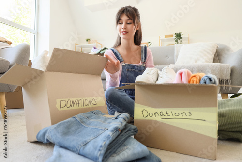 Young woman packing clothes...