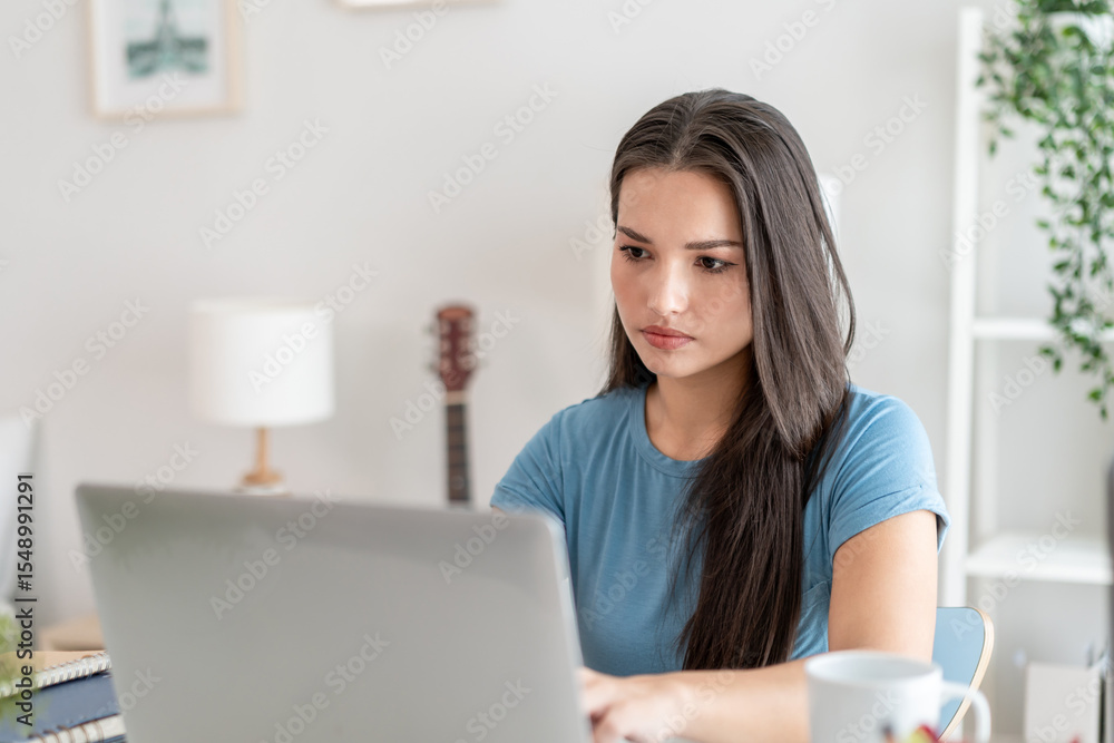 Depressed Asian woman freelancer using laptop device working in house. Depressed Asian woman freelancer using laptop device working in house.