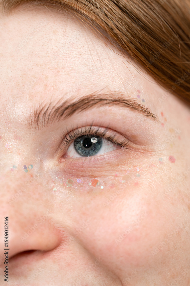 Fototapeta premium Portrait of woman with glitter around her eyes