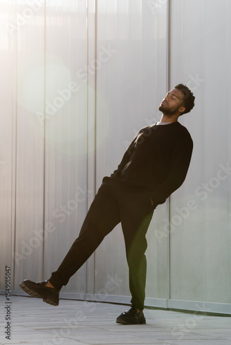 Man leaning back with glare around him