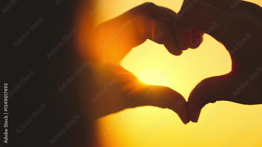Fototapeta premium showing heart sign with hands silhouette, close-up, happy girl traveler at sunset, african american multicultural at sunset, adolescence dream, romantic love country usa, fun leisure young adult, girl