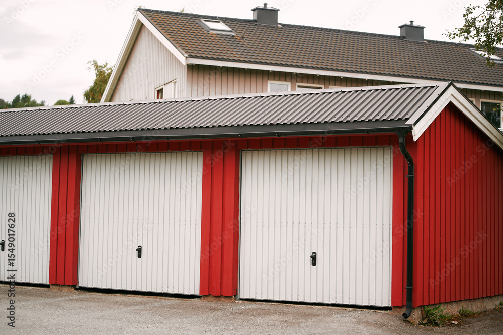Naklejka premium Red garage units with white doors in a suburban area