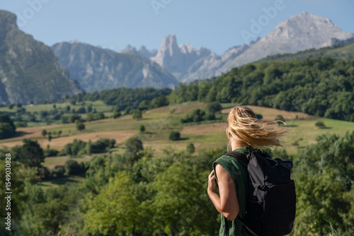Woman standing on the rock with a backpack