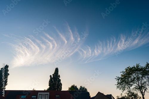Beautiful cloud filaments of cirrus fibratus are contrasting sharply against the blue sky