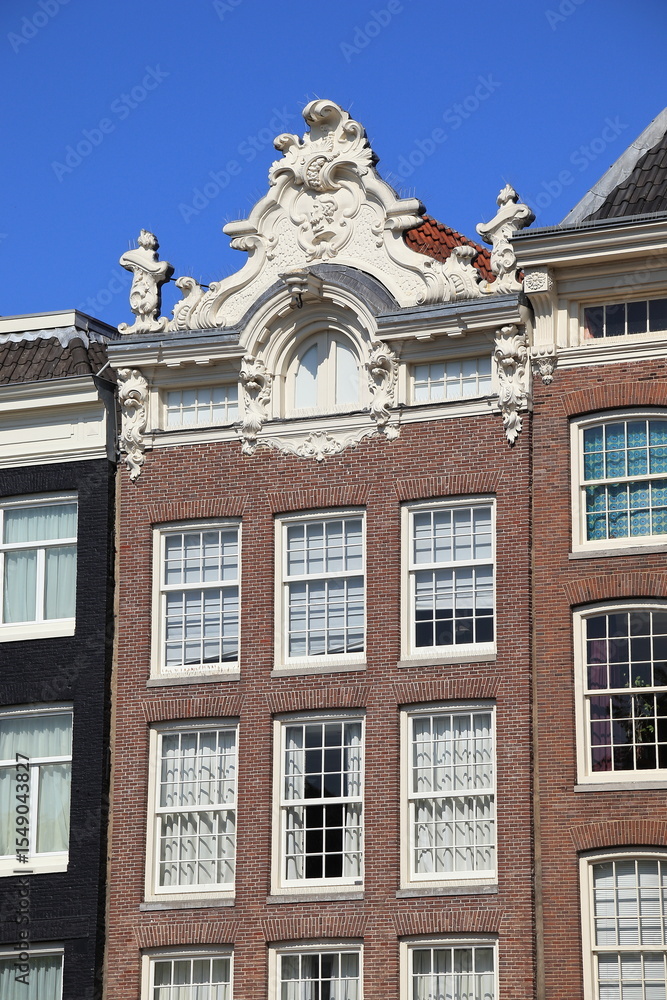 Fototapeta premium Prinsengracht Canal House Facade with Sculpted Roof Decoration in Amsterdam, Netherlands