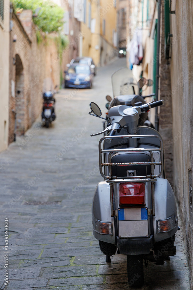 Fototapeta premium Close-up of the Rear End of a Motorcycle Parked on the Streets of Siena, Tuscany, Italy