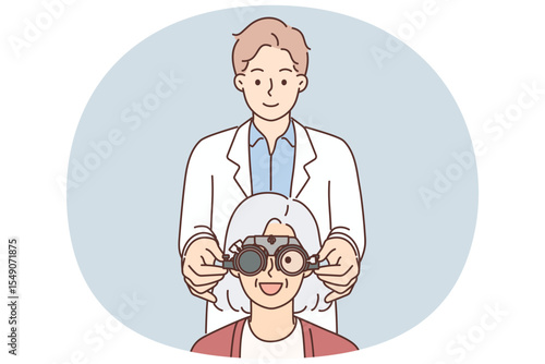Man optometrist putting on ophthalmic glasses on elderly female patient during vision treatment