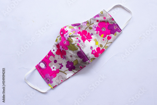 Konstfotografi cloth mask or fabric face mask with cotton fabric flower pattern handmade crafts isolated on white background