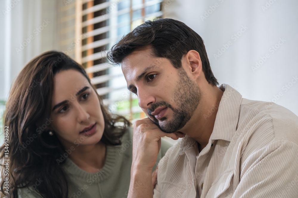 Naklejka premium Supportive couple in emotional moment at home as woman struggles with sadness and stress, expressing