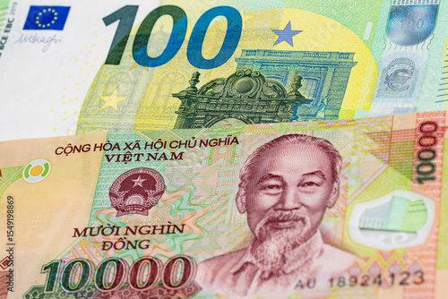 Wallpaper Mural 100 euro and 10000 Vietnamese dong banknotes. International trade concept Torontodigital.ca