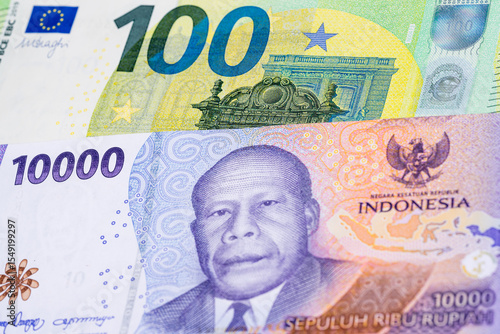 Wallpaper Mural 100 euro and 10000 Indonesian rupee banknotes. International trade concept Torontodigital.ca