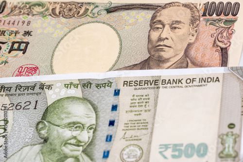 10000 Japanese yen and 500 Indian rupee banknotes. International trade concept