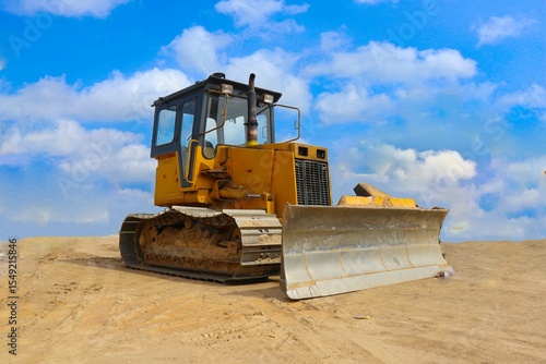 Bilde på lerret bulldozer with yellow color, on construction site and sky background