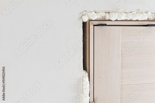 apartment renovation, close-up of door frame installation, removal of mounting foam