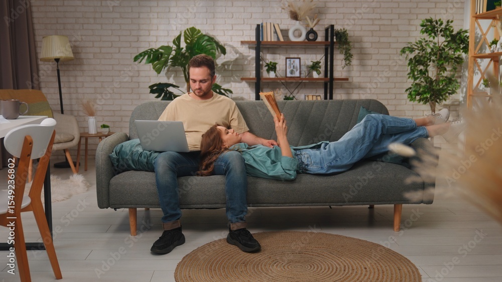 Obraz premium Cozy Couple Relaxing in Modern Living Room on Comfortable Sofa