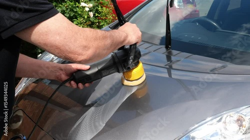 Process of polishing silver car body surface using orbital polishing machine.