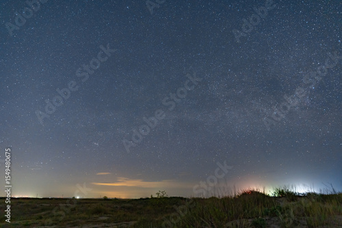 The Milky Way arches above a remote wild beach on the Black Sea coast, captured on a warm summer night free from light pollution – a serene astrophotography scene of stars, sea, and solitude