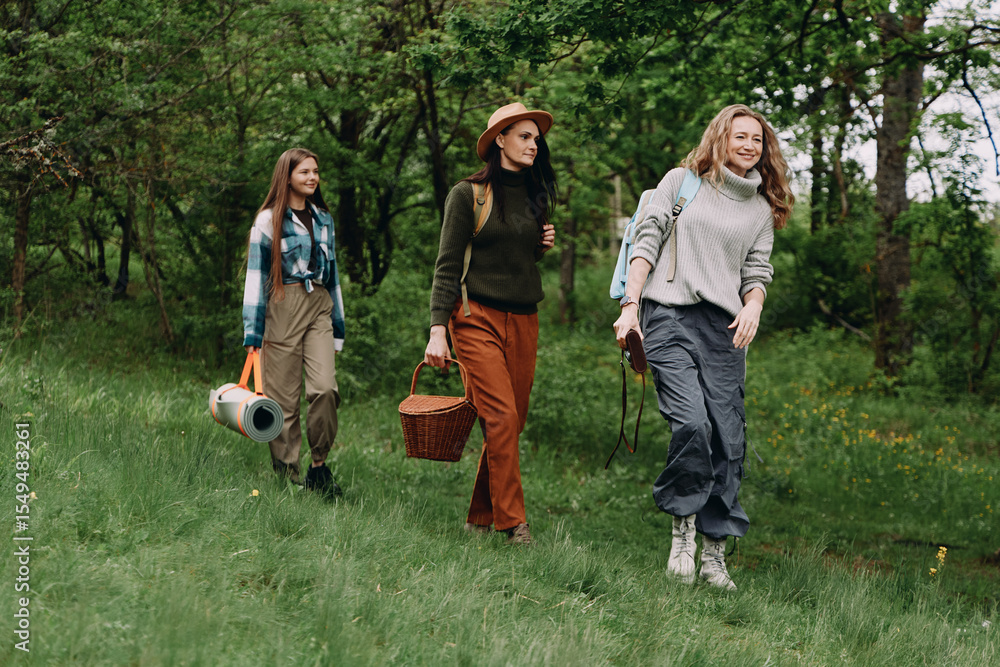 Obraz premium Active middle age woman leading community hike in green forest, promoting fitness, wellbeing, and healthy lifestyle among older women in nature, enjoying wellness and longevity outdoors.