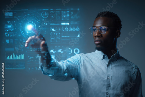 Young entrepreneur using futuristic interface hologram, data charts floating mid-air